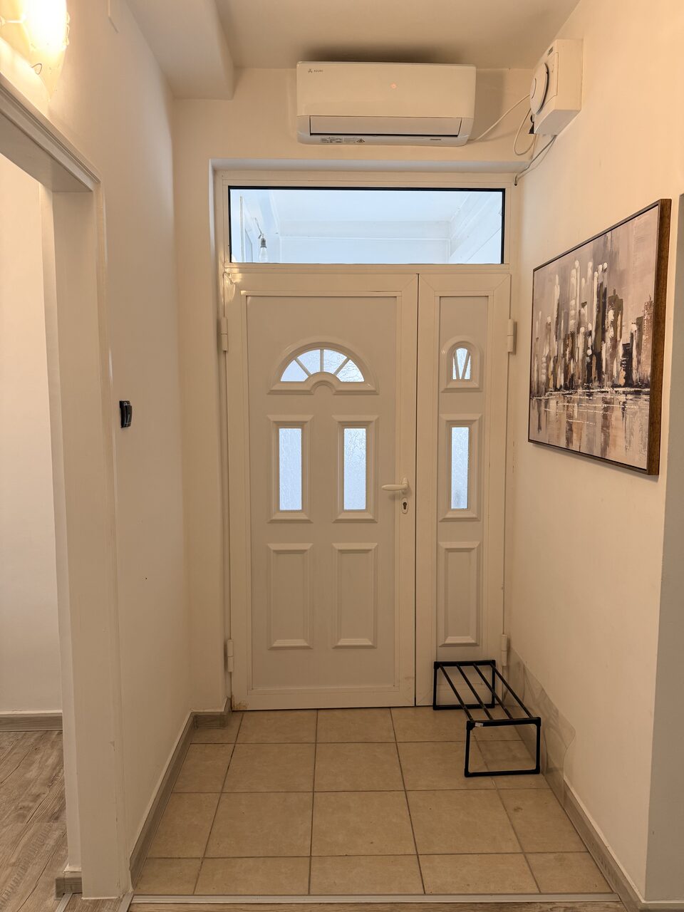 Entrance hall with classic white front door and air conditioning